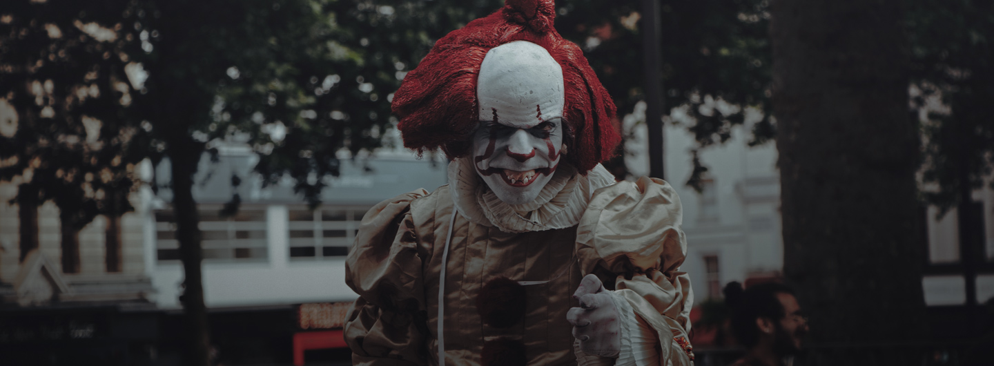 Düsteres Foto eines gruselig aussehenden Clowns auf einer Straße